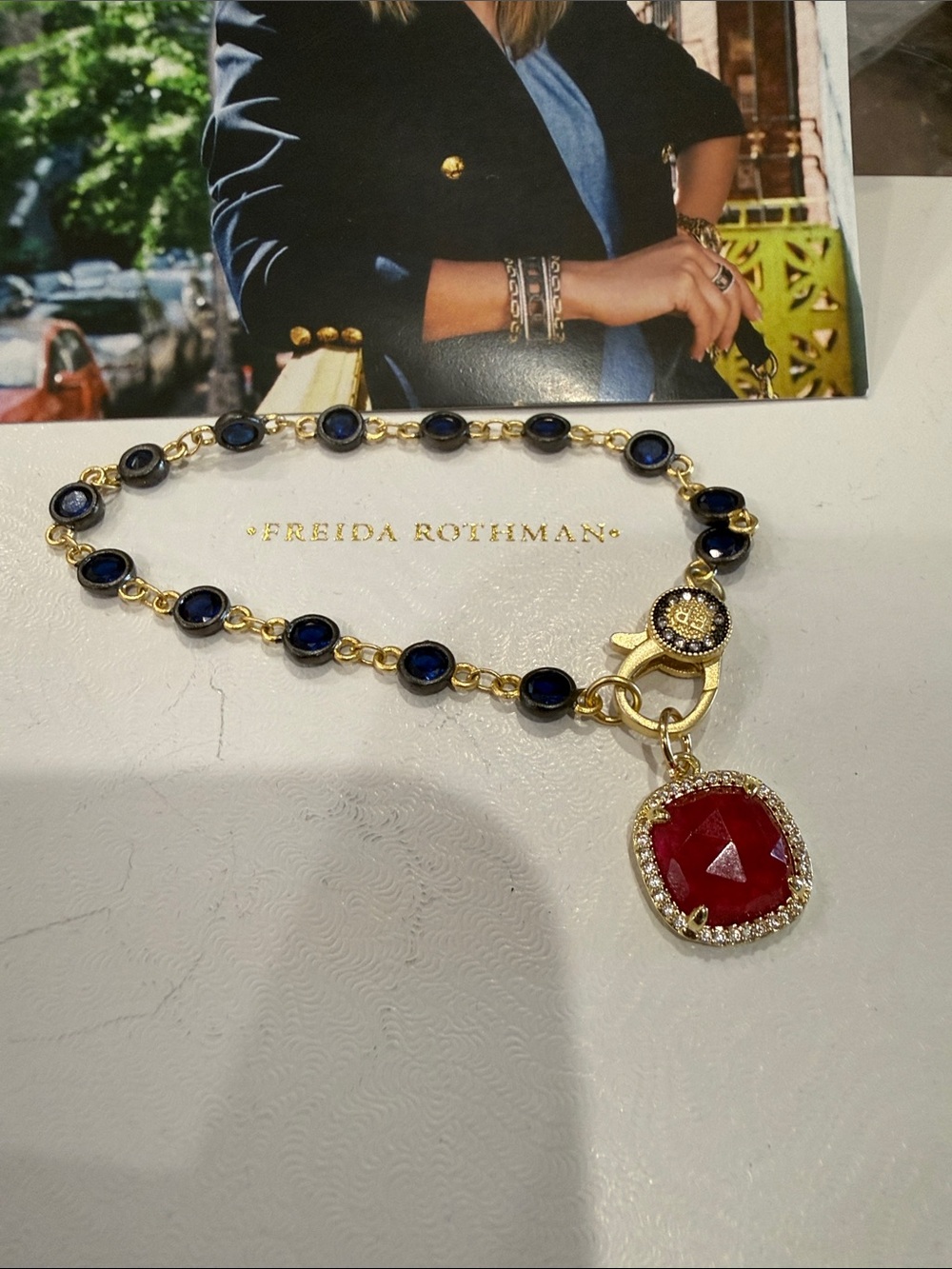 Freida Rothman Sterling Gold Bracelet with Blue Bezel Stones and Red Pendant